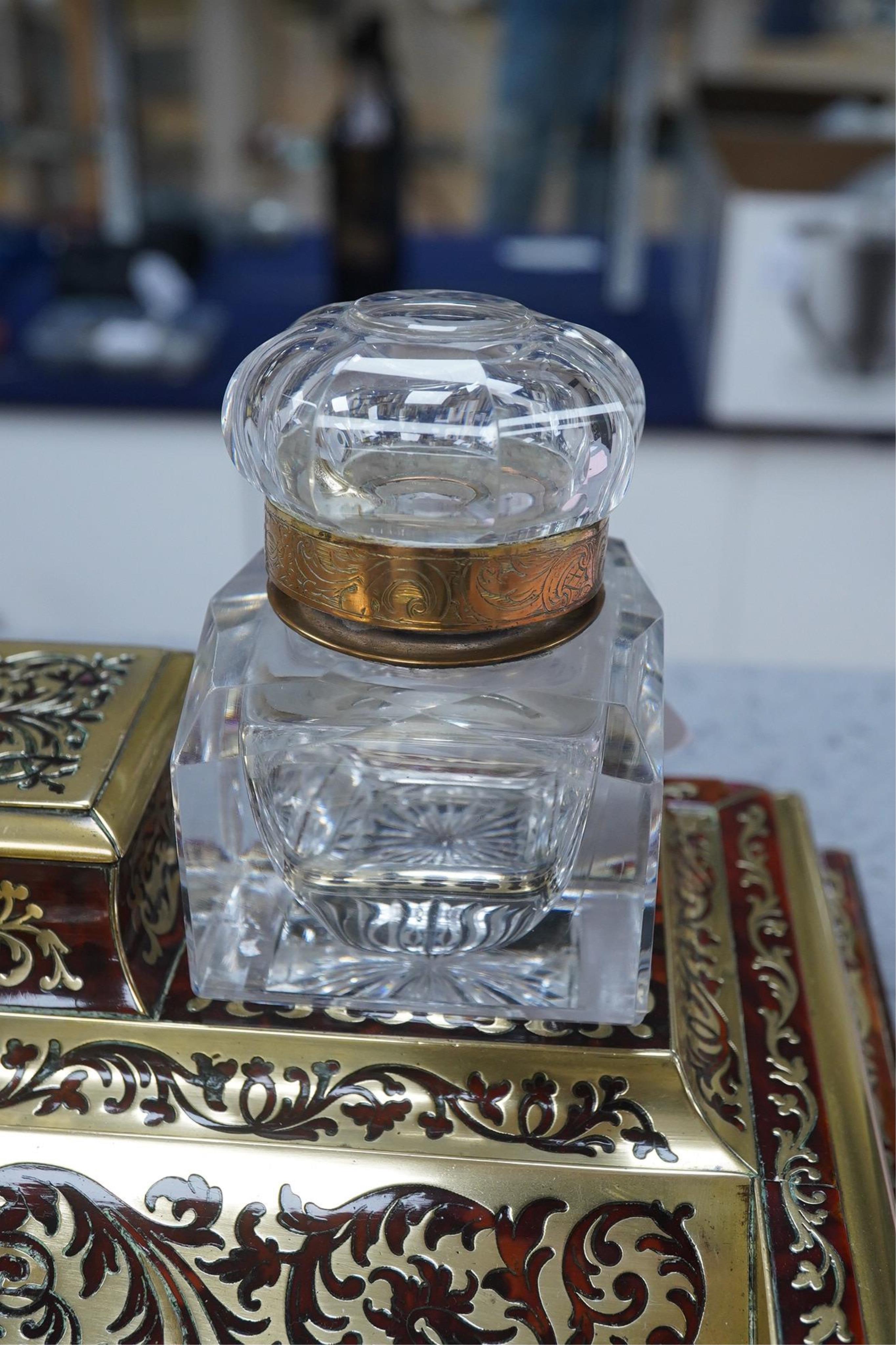 A French scarlet boullework double inkstand with original glass ink bottles c.1850, 39cm wide. Condition - inkstand good, one inkwell cover missing